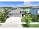 Aerial view of a two-story home with three car garage, paver driveway and water views at 14610 Red Castle Ave, Lithia, FL 33547