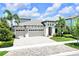 Charming two-story home with a three car garage, paver driveway and tropical landscaping at 14610 Red Castle Ave, Lithia, FL 33547