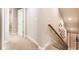 Hallway featuring carpet flooring, neutral paint, and a wood handrail at 14610 Red Castle Ave, Lithia, FL 33547