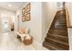 Hallway features wood stairs, tile flooring, neutral paint, and Gathering photos on the wall at 14610 Red Castle Ave, Lithia, FL 33547