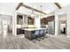 Modern kitchen with dark cabinets, stainless steel appliances, a marble island, and tile floors at 14610 Red Castle Ave, Lithia, FL 33547