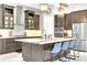 Modern kitchen with stainless steel appliances, a large island, and designer pendant lighting at 14610 Red Castle Ave, Lithia, FL 33547