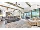 Open concept living area featuring wood beams, tile flooring, comfortable seating, and a view of the outdoor patio at 14610 Red Castle Ave, Lithia, FL 33547