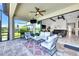 Relaxing covered patio with outdoor seating, a ceiling fan, and views of the spacious living area at 14610 Red Castle Ave, Lithia, FL 33547