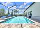 The screened-in pool offers a relaxing oasis with a built-in spa and plenty of space for lounging at 14610 Red Castle Ave, Lithia, FL 33547