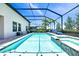 A pristine screened-in pool is accompanied by lounge chairs, a spa, and lush landscaping at 14610 Red Castle Ave, Lithia, FL 33547
