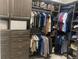 Spacious walk-in closet with custom shelving and ample storage space for clothing and accessories at 14610 Red Castle Ave, Lithia, FL 33547