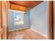 Bright bedroom featuring blue walls, a wood ceiling, and a sunlit window offering a pleasant view at 1501 W Trapnell Rd, Plant City, FL 33566