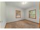 Bedroom featuring neutral walls, carpeted floors, and natural light from windows at 1501 W Trapnell Rd, Plant City, FL 33566