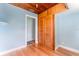 Bright bedroom featuring blue walls, wooden floors and a closet with doors at 1501 W Trapnell Rd, Plant City, FL 33566