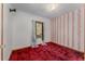 Bedroom features bold wallpaper, vibrant red carpet, and a window at 1501 W Trapnell Rd, Plant City, FL 33566