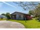 Charming home with a stone chimney and well-maintained lawn in a quiet, green neighborhood at 1501 W Trapnell Rd, Plant City, FL 33566