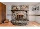 A stone fireplace with a wood mantel and hearth in a large room at 1501 W Trapnell Rd, Plant City, FL 33566