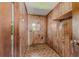 Practical laundry room with wood paneled walls and patterned linoleum flooring at 1501 W Trapnell Rd, Plant City, FL 33566