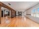 Spacious living room with hardwood floors, shuttered windows and a stone fireplace at 1501 W Trapnell Rd, Plant City, FL 33566