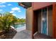 A modern outdoor shower near the pool and well-manicured landscaping enhances the backyard's appeal at 1550 Marinella Dr, Palm Harbor, FL 34683