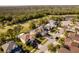 Aerial view featuring the home's location on a quiet street near green spaces and a pond at 15618 Shoal Creek Pl, Odessa, FL 33556