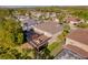 Aerial view of a two-story home with a screened-in pool and a second-story deck with comfortable seating at 15618 Shoal Creek Pl, Odessa, FL 33556