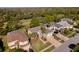An aerial view of a home surrounded by lush greenery, a golf course and neighboring houses at 15618 Shoal Creek Pl, Odessa, FL 33556