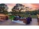 Cozy back deck with comfortable seating, outdoor lighting, and peaceful golf course views at 15618 Shoal Creek Pl, Odessa, FL 33556