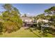 View of the home exterior, pool, and deck from the backyard, showcasing outdoor living spaces at 15618 Shoal Creek Pl, Odessa, FL 33556
