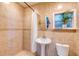 Bathroom features walk-in shower and pedestal sink at 15618 Shoal Creek Pl, Odessa, FL 33556