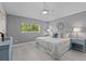 Cozy bedroom with hardwood floors, ample natural light, and soothing color palette at 15618 Shoal Creek Pl, Odessa, FL 33556