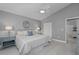 Comfortable bedroom featuring a ceiling fan, neutral walls, and closet storage at 15618 Shoal Creek Pl, Odessa, FL 33556