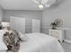 Comfortable bedroom with neutral tones, a ceiling fan, and ample closet space at 15618 Shoal Creek Pl, Odessa, FL 33556