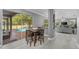 Dining area adjacent to the screened patio overlooking the pool, creating a seamless indoor-outdoor living experience at 15618 Shoal Creek Pl, Odessa, FL 33556