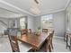 Dining area with wood table, decorative lighting, and sightlines into the adjacent living spaces at 15618 Shoal Creek Pl, Odessa, FL 33556