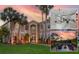 Stunning two-story home boasting lush landscaping, mature palms, and a warm, inviting exterior at 15618 Shoal Creek Pl, Odessa, FL 33556
