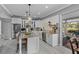 Bright and airy kitchen featuring white cabinetry, stainless steel appliances, and breakfast bar seating at 15618 Shoal Creek Pl, Odessa, FL 33556