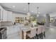 Modern kitchen featuring an island with bar seating, granite countertops, and access to outdoor dining at 15618 Shoal Creek Pl, Odessa, FL 33556