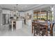 Modern kitchen with stainless steel appliances, island with seating, and a view of the screened in lanai at 15618 Shoal Creek Pl, Odessa, FL 33556