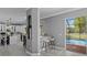 Kitchen transitions to pool area, featuring bar seating and lots of natural light at 15618 Shoal Creek Pl, Odessa, FL 33556