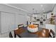 Dining area view of modern kitchen featuring white cabinetry, stainless appliances, and granite countertops at 15618 Shoal Creek Pl, Odessa, FL 33556