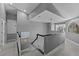 Upper landing with black and white railing, tray ceiling and lots of natural light at 15618 Shoal Creek Pl, Odessa, FL 33556