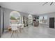 Open living area with bright windows, a small table, and modern white shelving at 15618 Shoal Creek Pl, Odessa, FL 33556