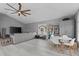 Open-concept living room with vaulted ceiling, modern flooring, and comfortable sectional sofa at 15618 Shoal Creek Pl, Odessa, FL 33556