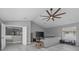 Comfortable living room with hardwood floors, large TV, and a ceiling fan at 15618 Shoal Creek Pl, Odessa, FL 33556
