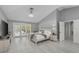 Spacious main bedroom featuring light wood flooring, a vaulted ceiling, and private access to the deck at 15618 Shoal Creek Pl, Odessa, FL 33556