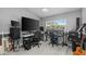 Home office with a large desk, multiple monitors, and plenty of natural light at 15618 Shoal Creek Pl, Odessa, FL 33556