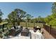 Outdoor patio with comfortable seating arrangements, offering serene views of the backyard and beyond at 15618 Shoal Creek Pl, Odessa, FL 33556