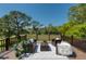 Outdoor patio with comfortable seating arrangements, offering serene views of the backyard and beyond at 15618 Shoal Creek Pl, Odessa, FL 33556