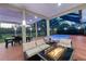 Outdoor patio featuring comfortable seating, dining area, and a beautiful pool view at 15618 Shoal Creek Pl, Odessa, FL 33556