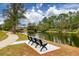 Scenic view of a pond with benches and a walking path at 15618 Shoal Creek Pl, Odessa, FL 33556