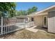 Charming backyard featuring a wooden fence, white picket fence, and access to the pool area at 18406 Sterling Silver Cir, Lutz, FL 33549