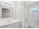 Clean and bright bathroom with subway tile shower and white vanity at 18406 Sterling Silver Cir, Lutz, FL 33549