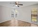 Bright bedroom with multiple windows providing natural light and new flooring at 18406 Sterling Silver Cir, Lutz, FL 33549